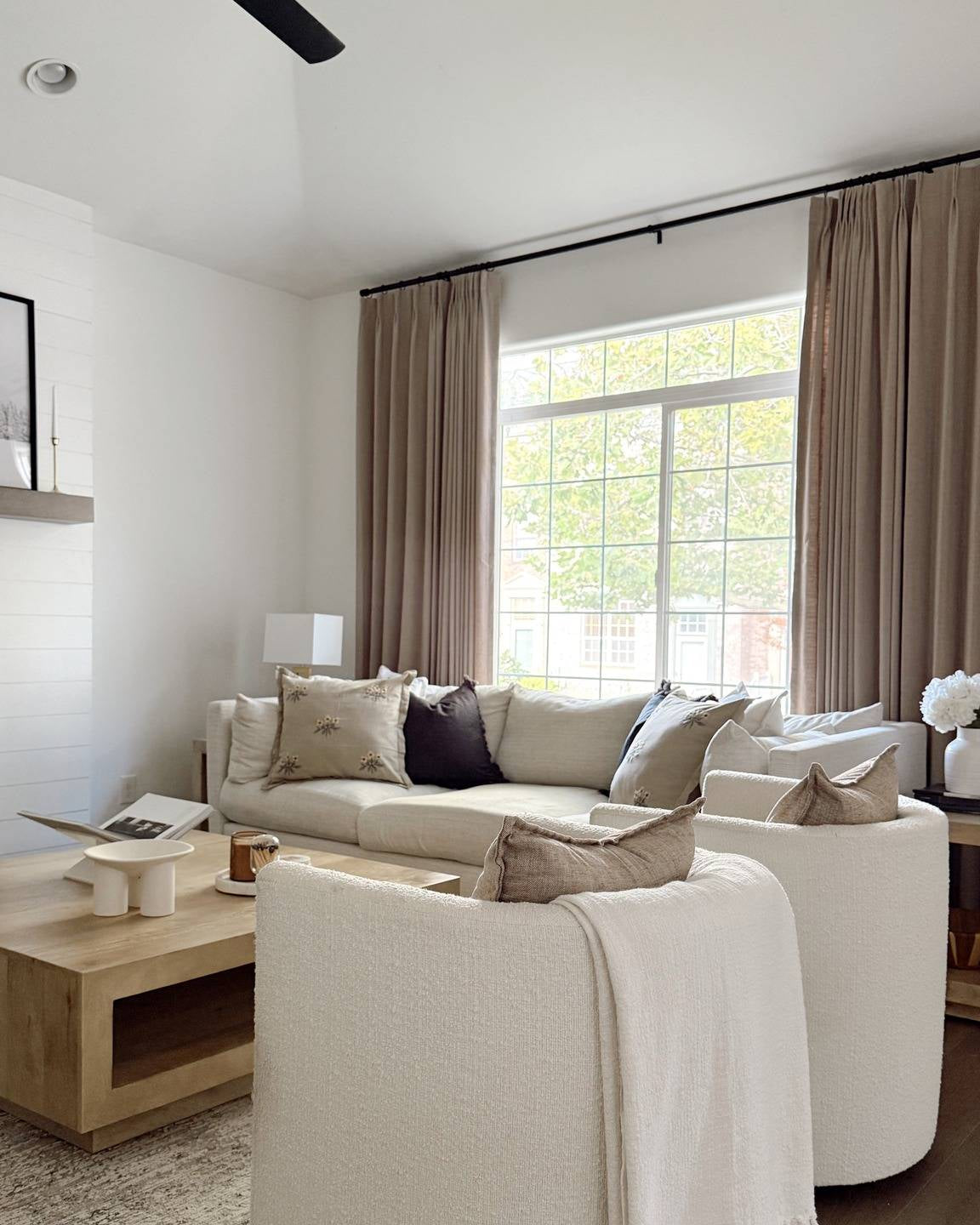 Lena Linen Soft Pebble-L2311 pleated drapery in a bright living and dining room