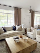 Lena Linen Soft Pebble-L2311 pleated drapery in a bright living and dining room